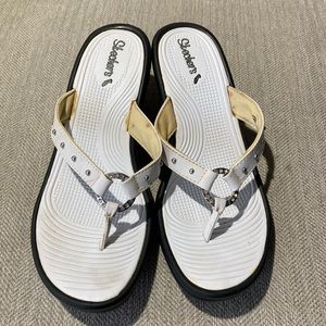 White leather wedges with silver detailing